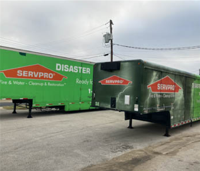 Disaster recovery trailer and truck parked outside.