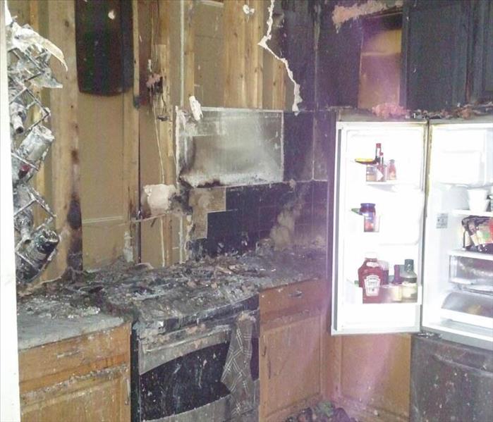 Kitchen with severe fire damage.