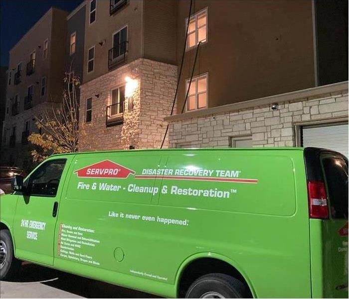Green van parked outside a residential property