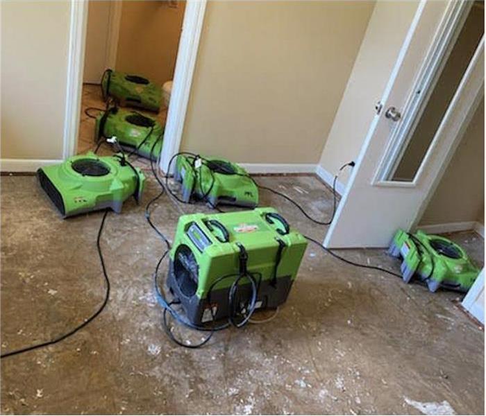 Five air movers placed in an area where water damage occur, flooring has been removed