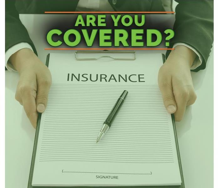 Hands holding a portfolio with an insurance form with the sentence  Are you covered?