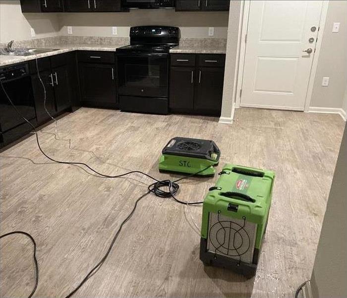 two air movers placed in a clean kitchen. Concept of water restoration services
